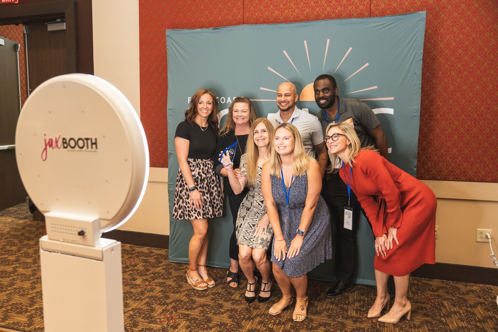 Award event attendees celebrate Regency's win at a photo booth