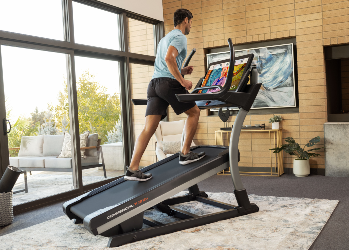 Man Using NordicTrack Incline Trainer in a Comparison Guide on the Different NordicTrack Treadmill Models