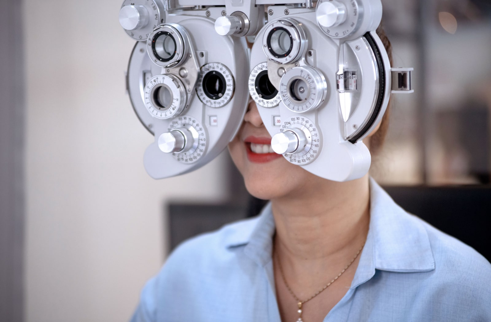 A woman gets her eyes examined by an optometrist