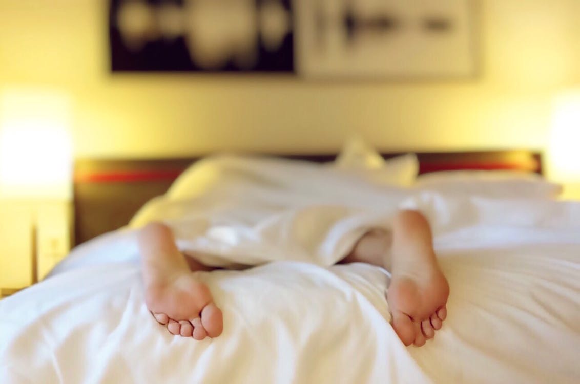 Free Person Lying on Bed Covering White Blanket Stock Photo