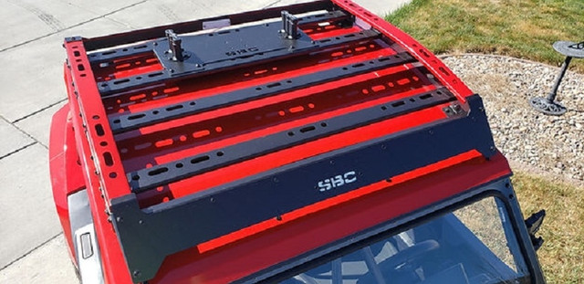 An Arctic Cat roof rack, installed on a UTV parked in a driveway