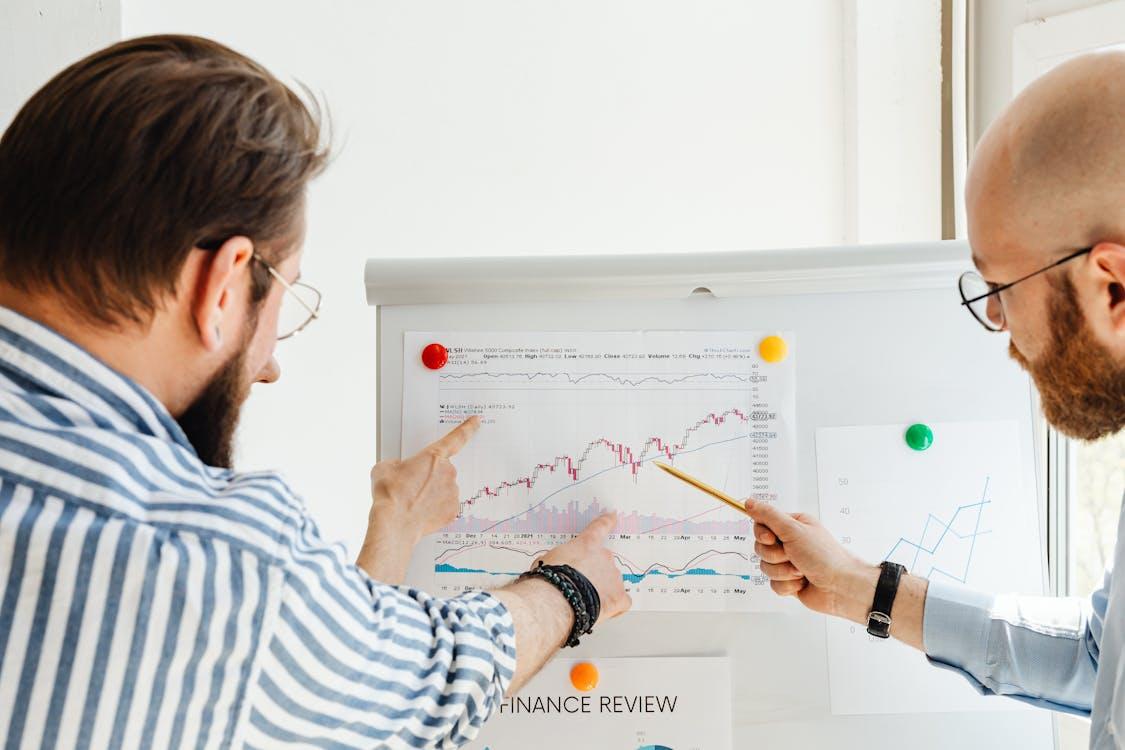 Free Two Men Discussing a Finance Review Stock Photo