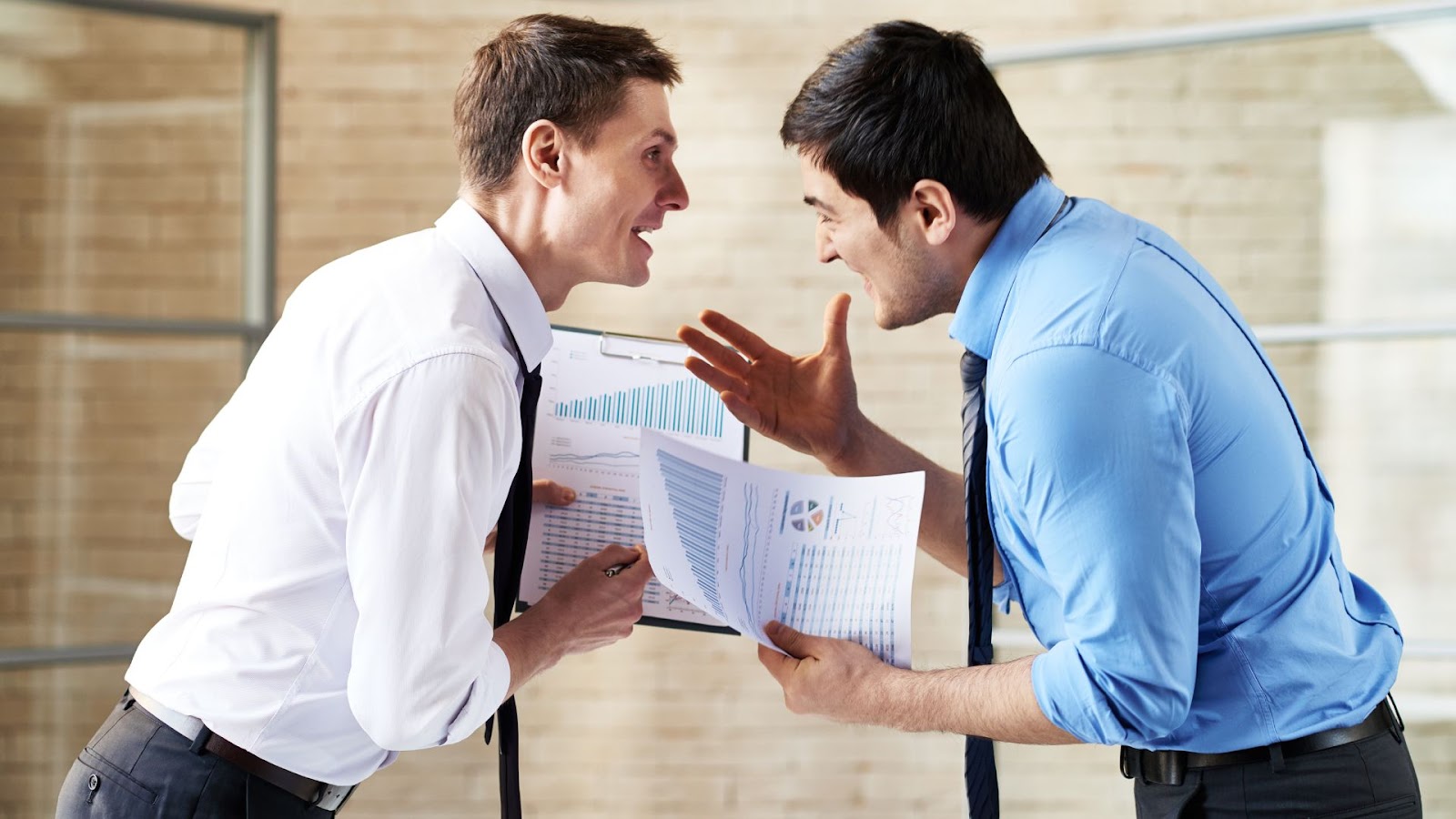 Two businessmen in a heated discussion, leaning towards each other with expressive gestures, holding papers with financial data.
