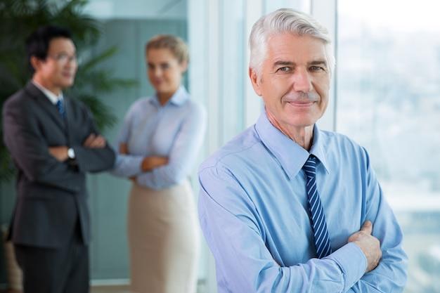 Closeup of smiling senior business man relaxing