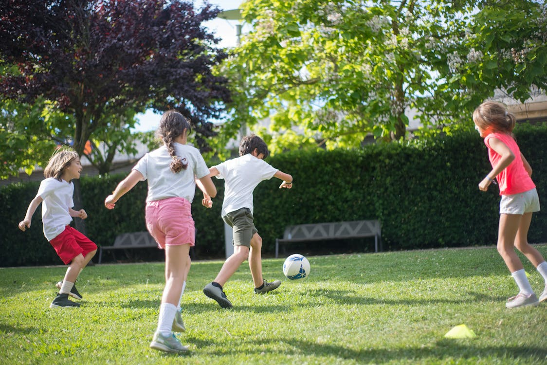 The kids are playing football, enhancing the team building.