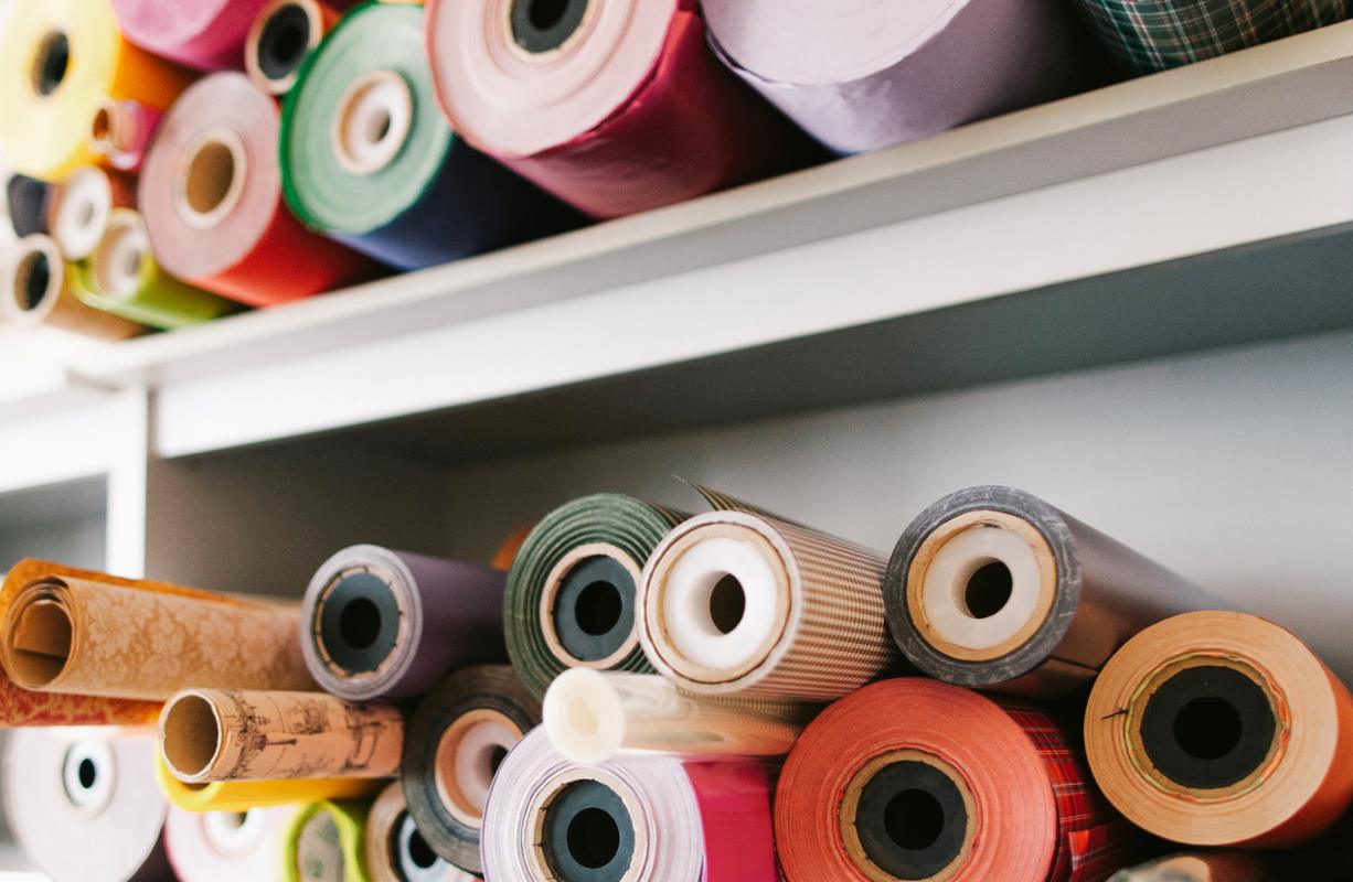 A wrapping paper assortment showcasing colorful rolls on shelves.