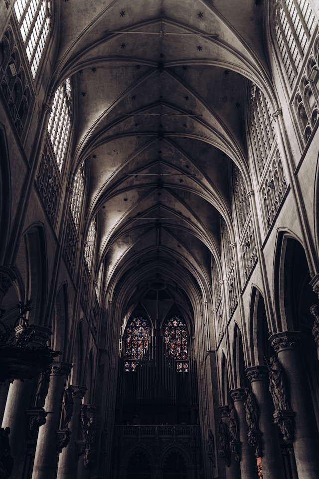 Ribbed vaults and stained glass windows inside a gothic church