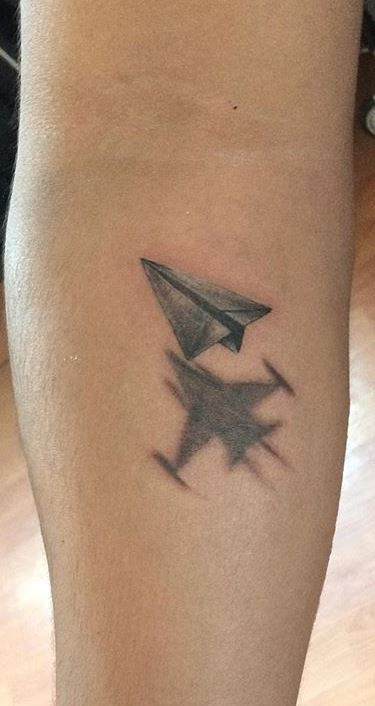 Paper airplane ankle tattoo design