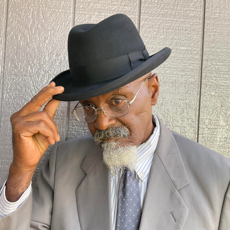 Picture of a man looking good with his homborg hat