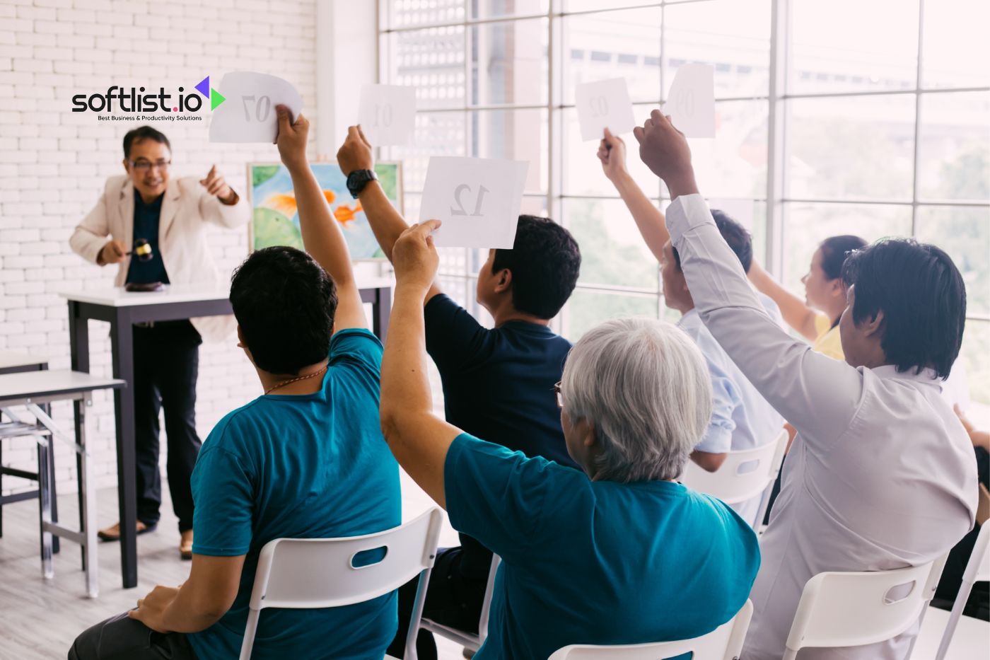 group of people raising their hand for bidding