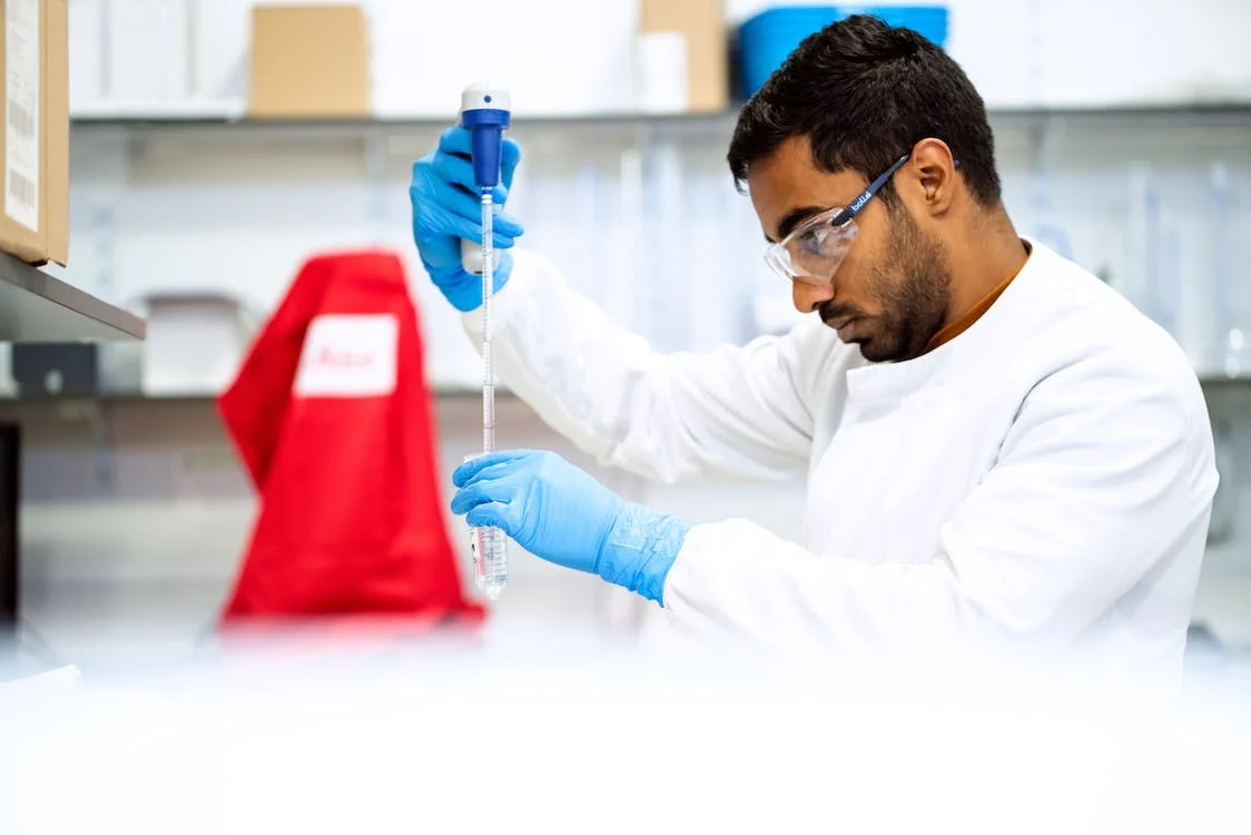 Scientist with white lab coat measuring stem cells