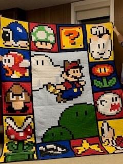 A blanket with cartoon characters on it

Description automatically generated