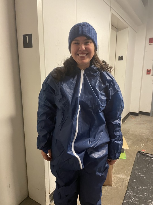 Waste Diversion fellow wearing blue protective suit and blue beanie.