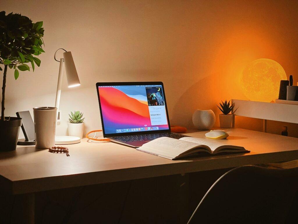 a study table with laptop and book - How to Study for Midterms