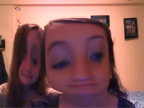 A hilarious photo booth video of two girls enjoying a funny filter.