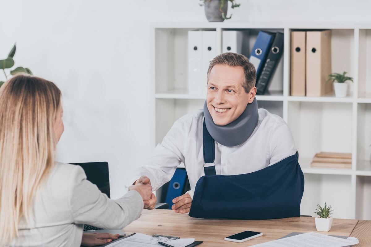 Injured employee shaking hands with his lawyer