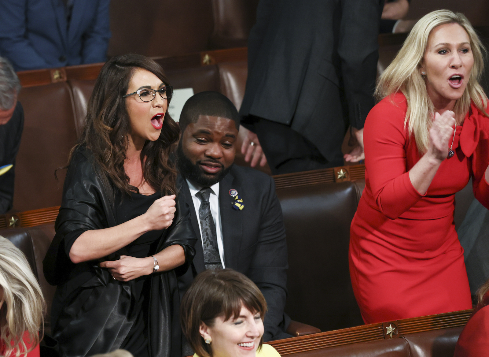 Reps. Lauren Boebert and Marjorie Taylor Greene rise to yell at President Biden during the State of the Union Address