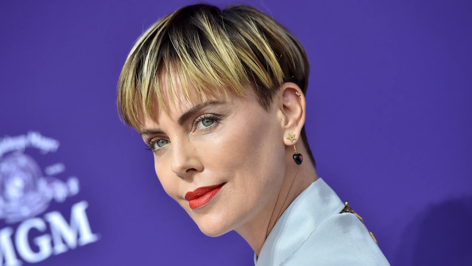 Picture of Charlize Theron looking dapper with her bowl cut