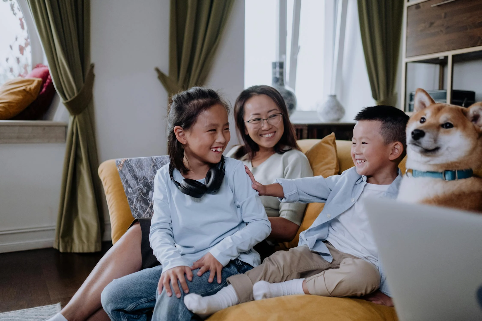 A family on the couch with a dog 