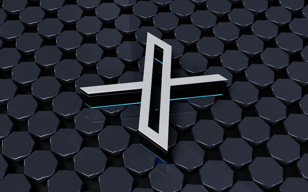 a white cross on a black background of hexagonal hexagons