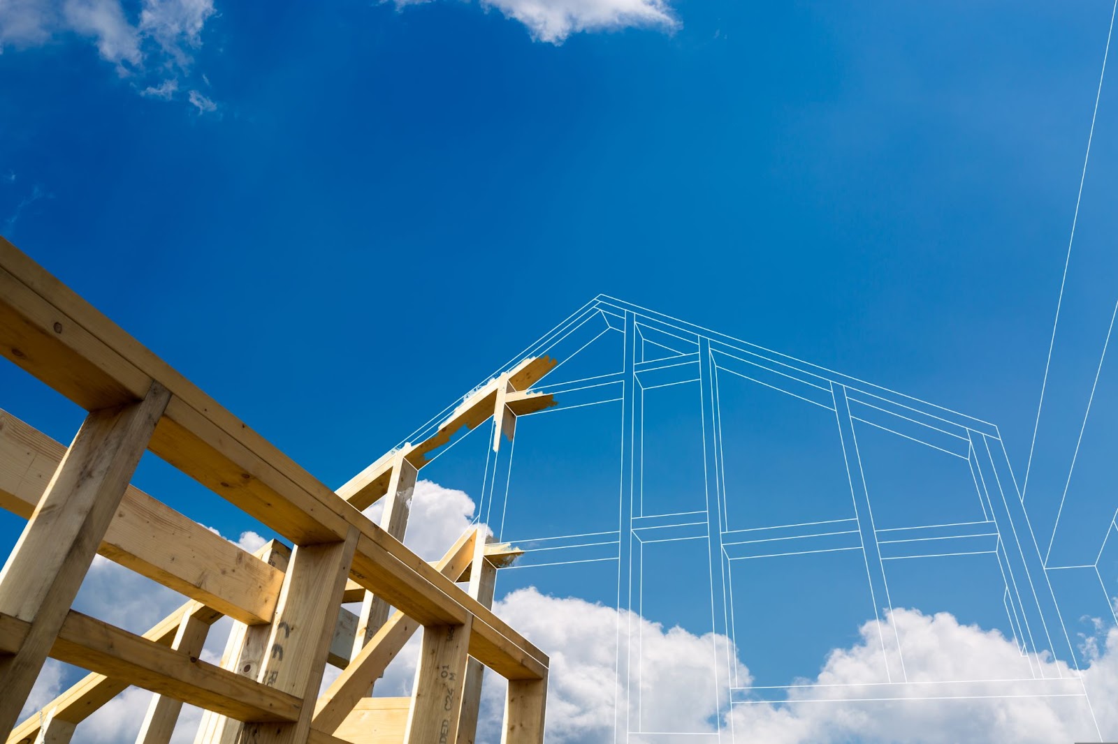 A house under construction against a blue sky backdrop.