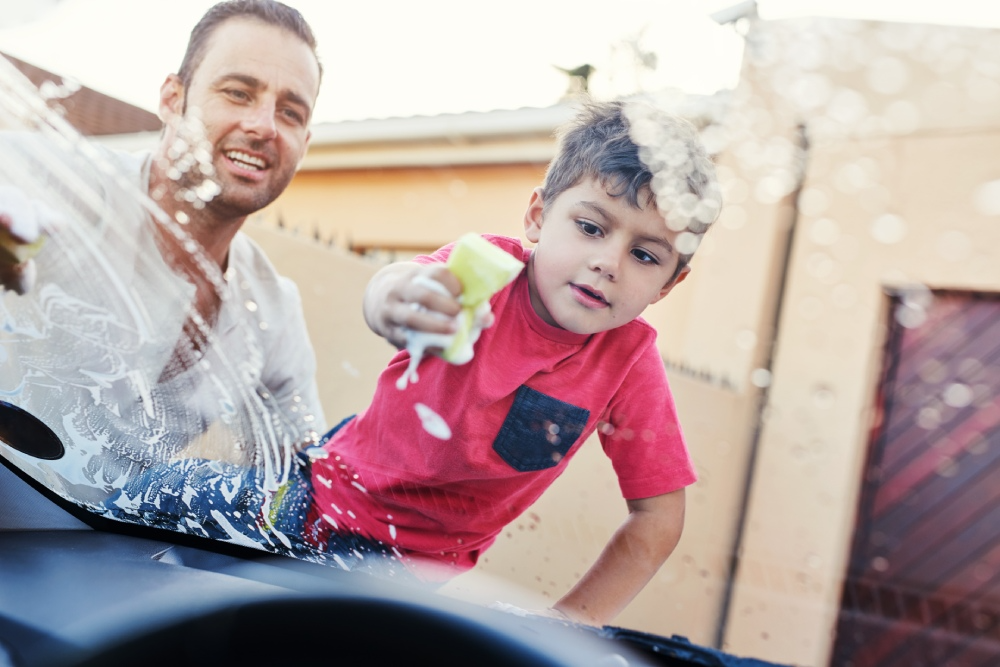 Father and son wash their car