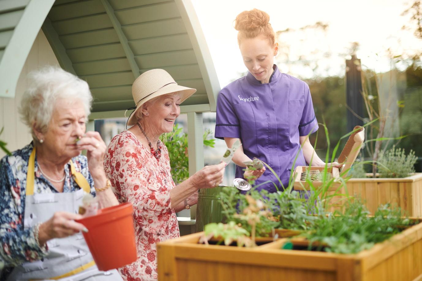 A group of women in a garden

Description automatically generated