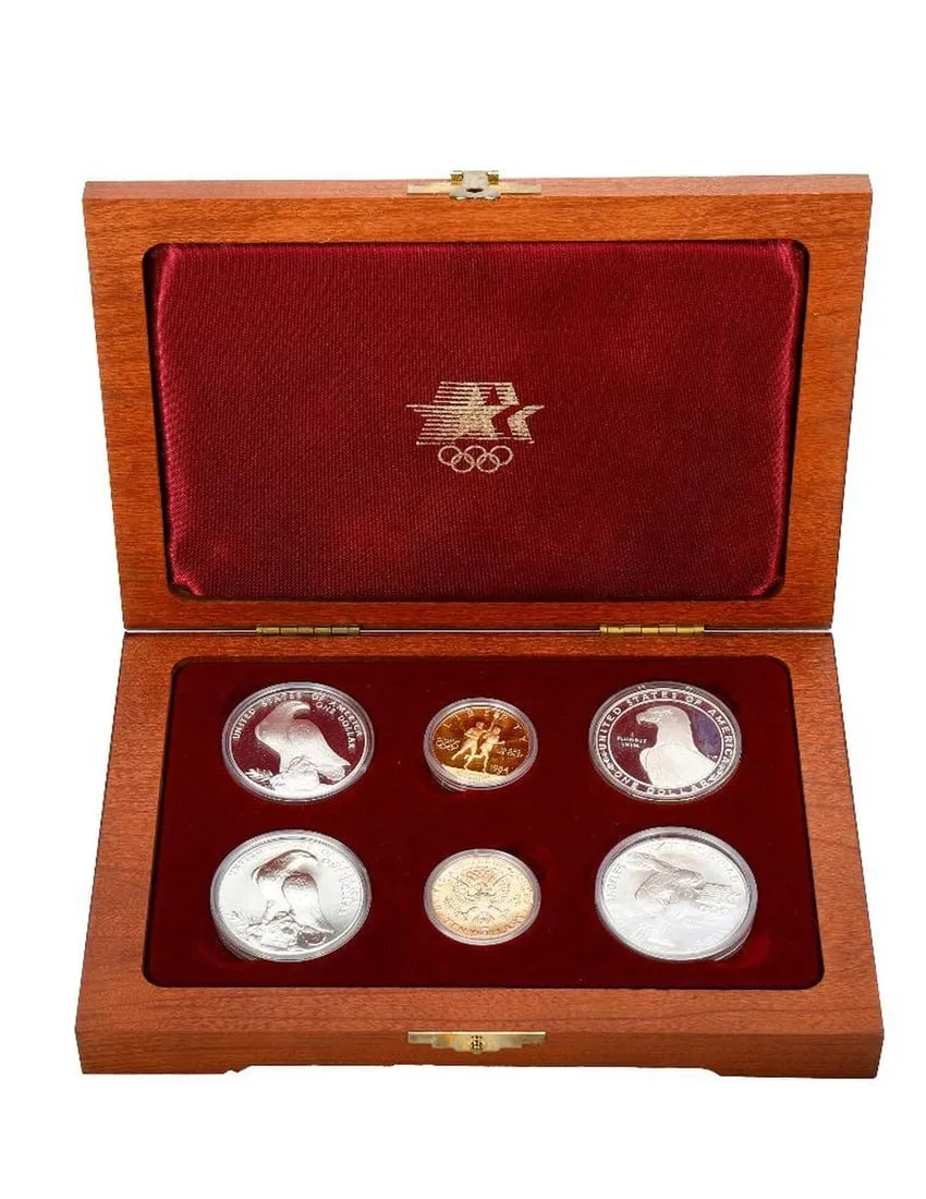A wooden box with silver coins in itDescription automatically generated