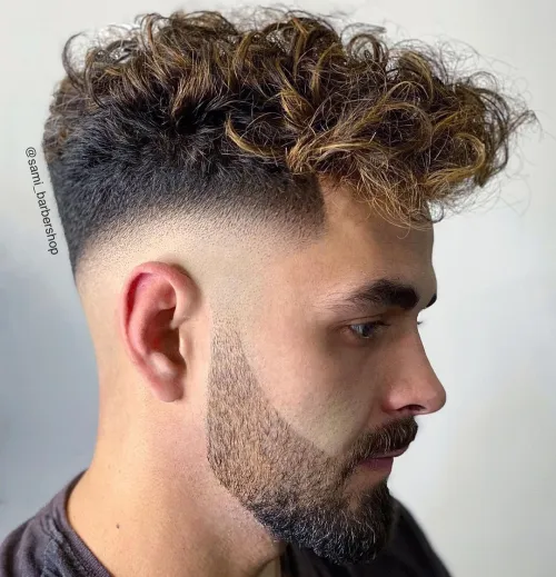 Picture of a guy with a side view of the iconic style with curls on top