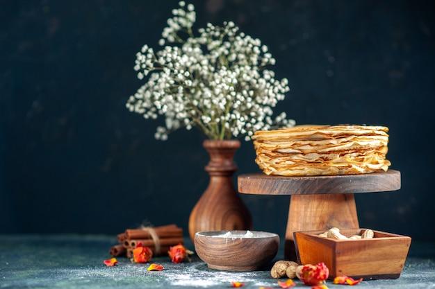 Front view delicious pancakes with nuts on dark blue milk dessert breakfast morning pie cake honey