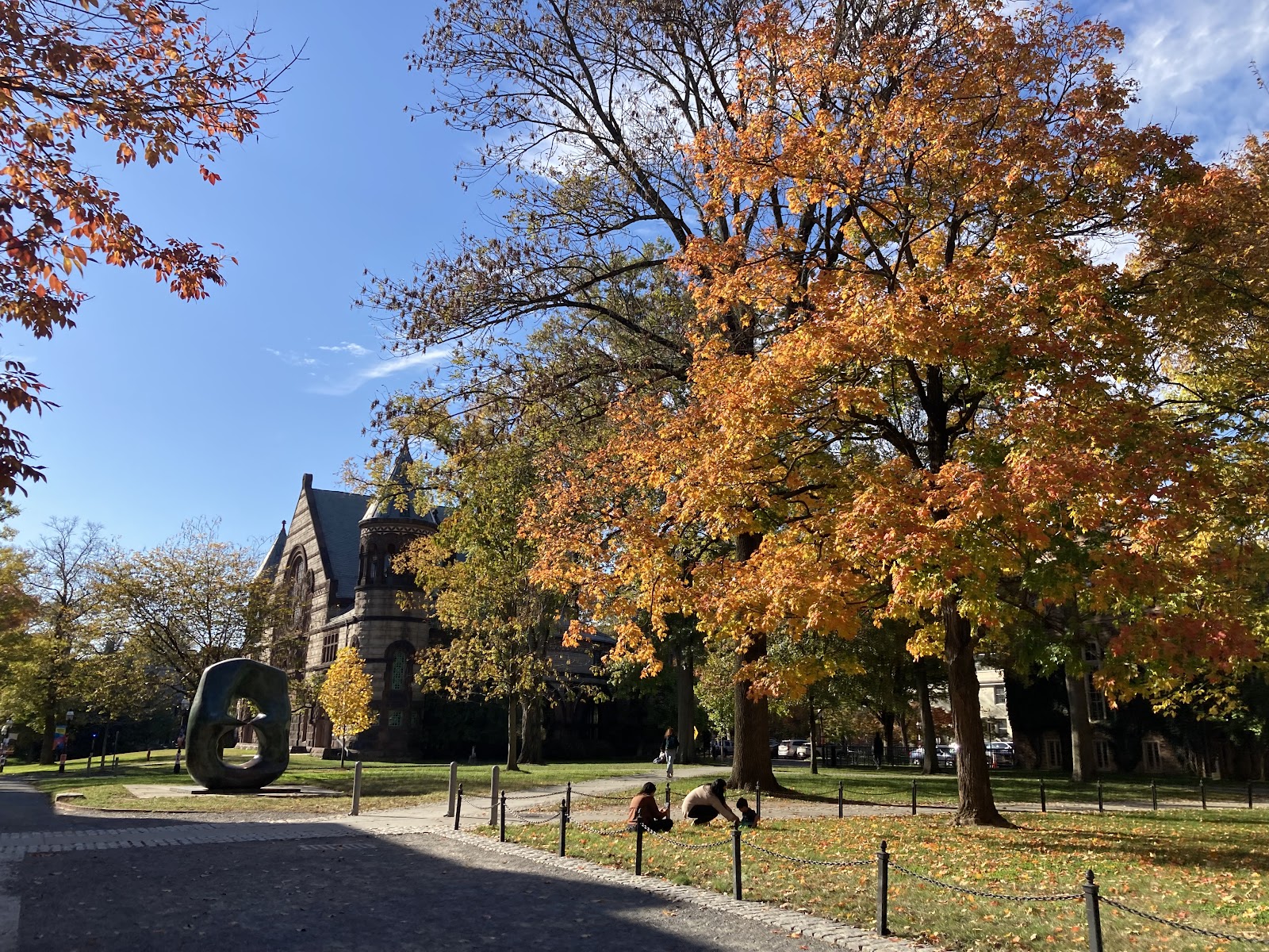 Fall foliage appears on trees surrounding Richardson Hall and Oval With Points sculpture