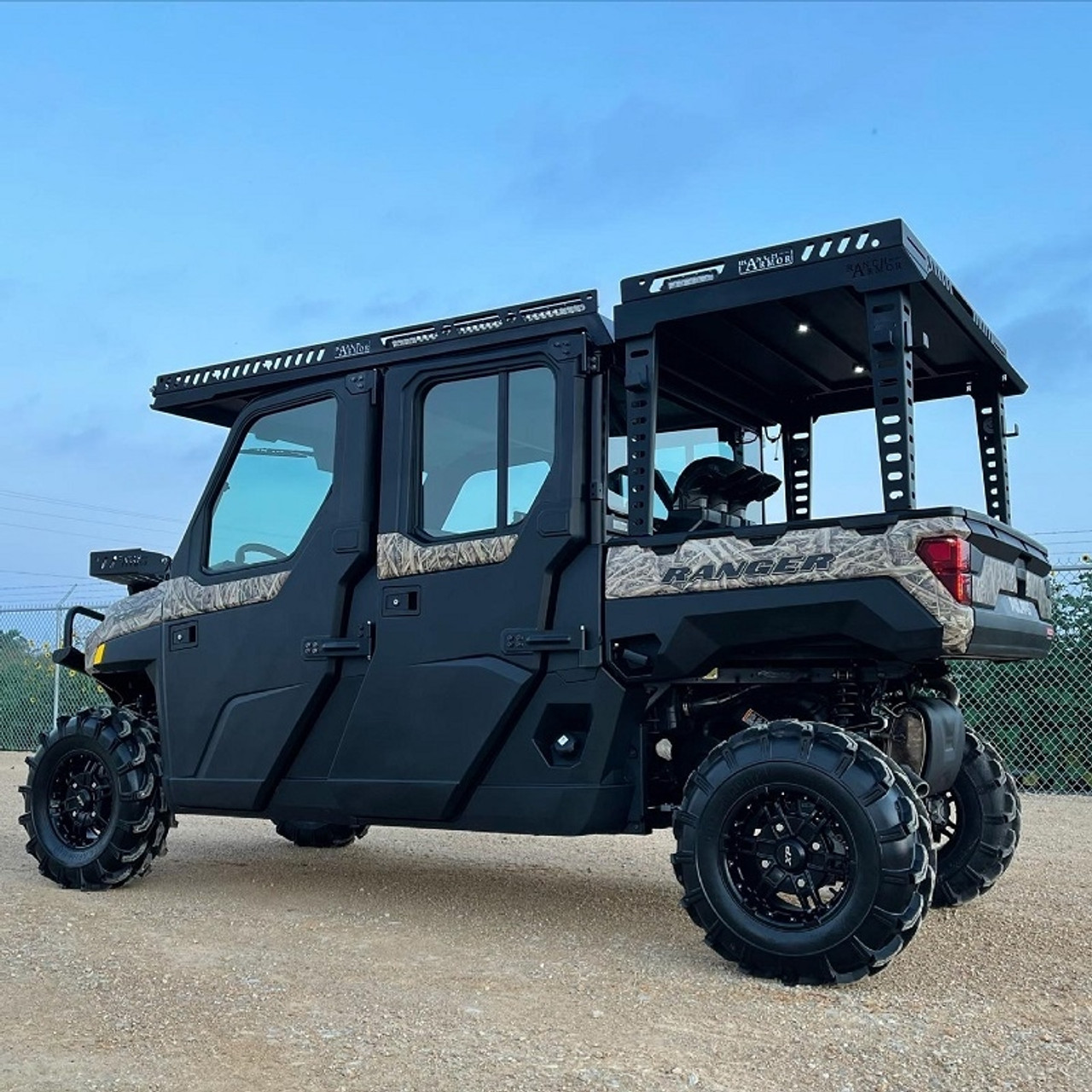 A side-facing image of a Polaris Ranger outfitted with a rear bed rack by Ranch Armor. 
