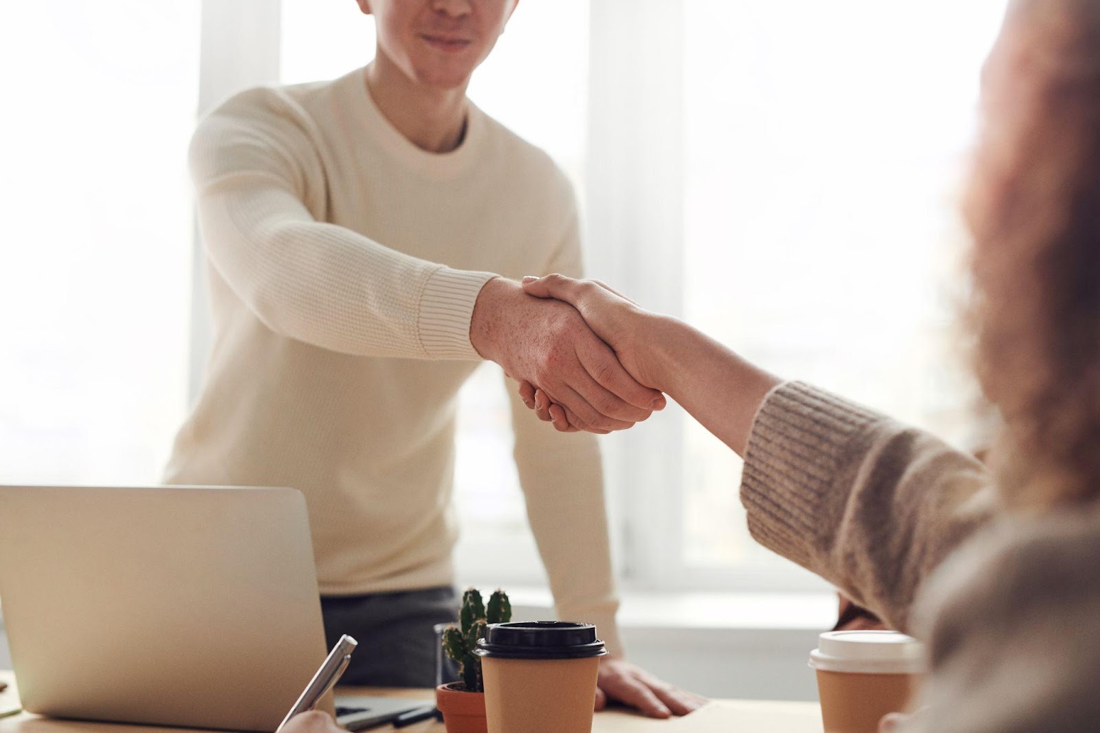  two people shaking hands after an interview