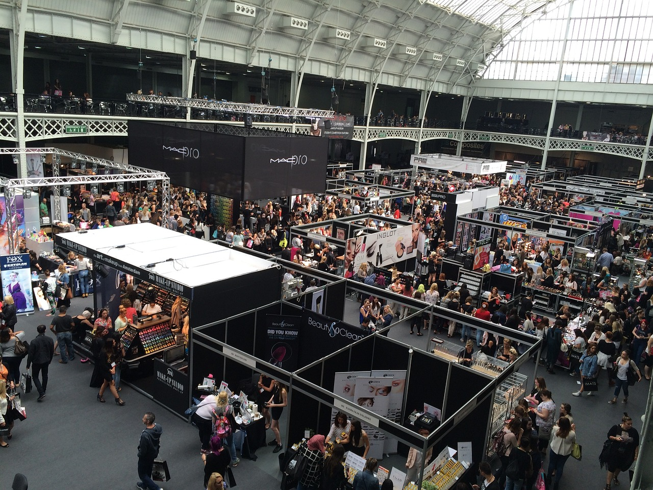 an overhead shot of a bustling trade show with multiple displays featuring large prints