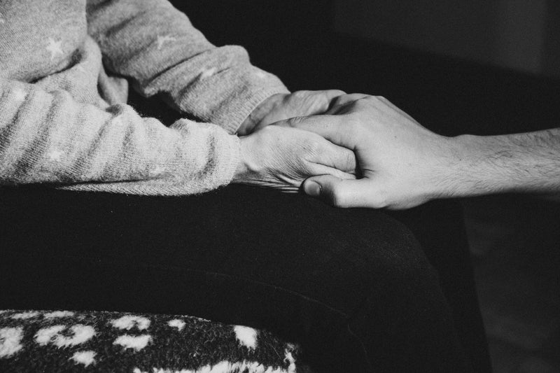 monochrome image of person holding someones elses hand - Image of Gemstones, A close-up image of a g