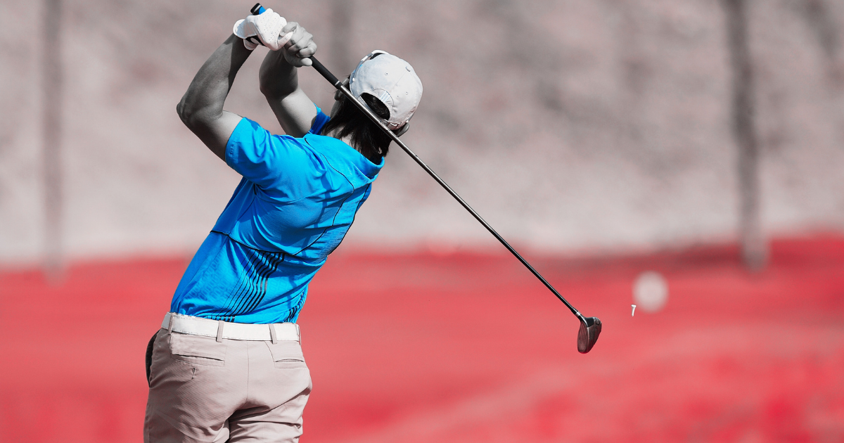 A golfer in mid-swing on an elaborately colored golf course featuring purple grass and green trees beneath a pastel sky, suggesting a powerful drive and skill. His body suggests such an impactful swing is typical of experienced players.