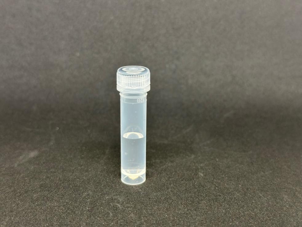A small plastic container with a clear liquid inside

Description automatically generated