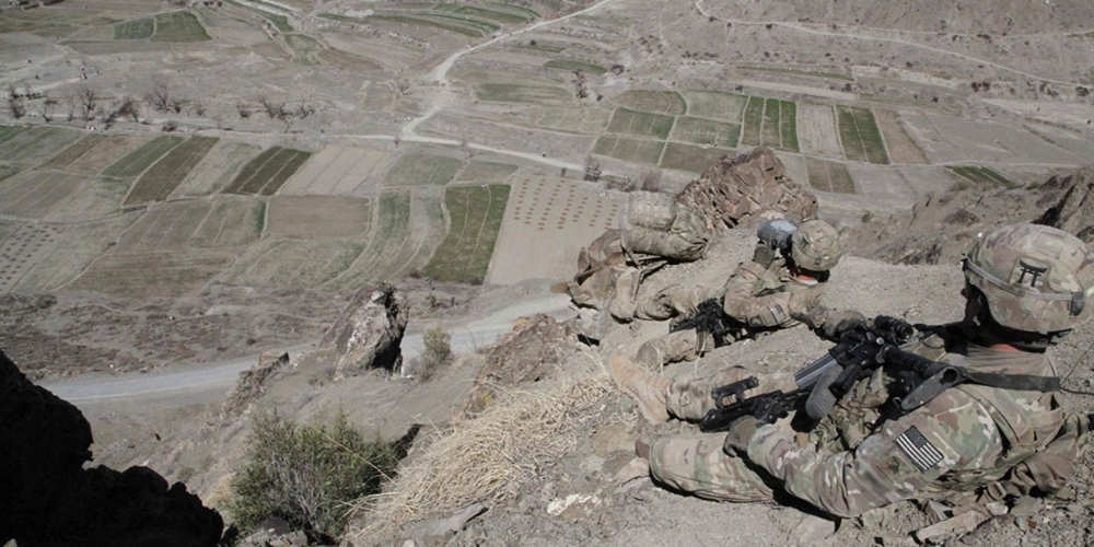 US Soldiers wearing multicam ACU blending into hillside