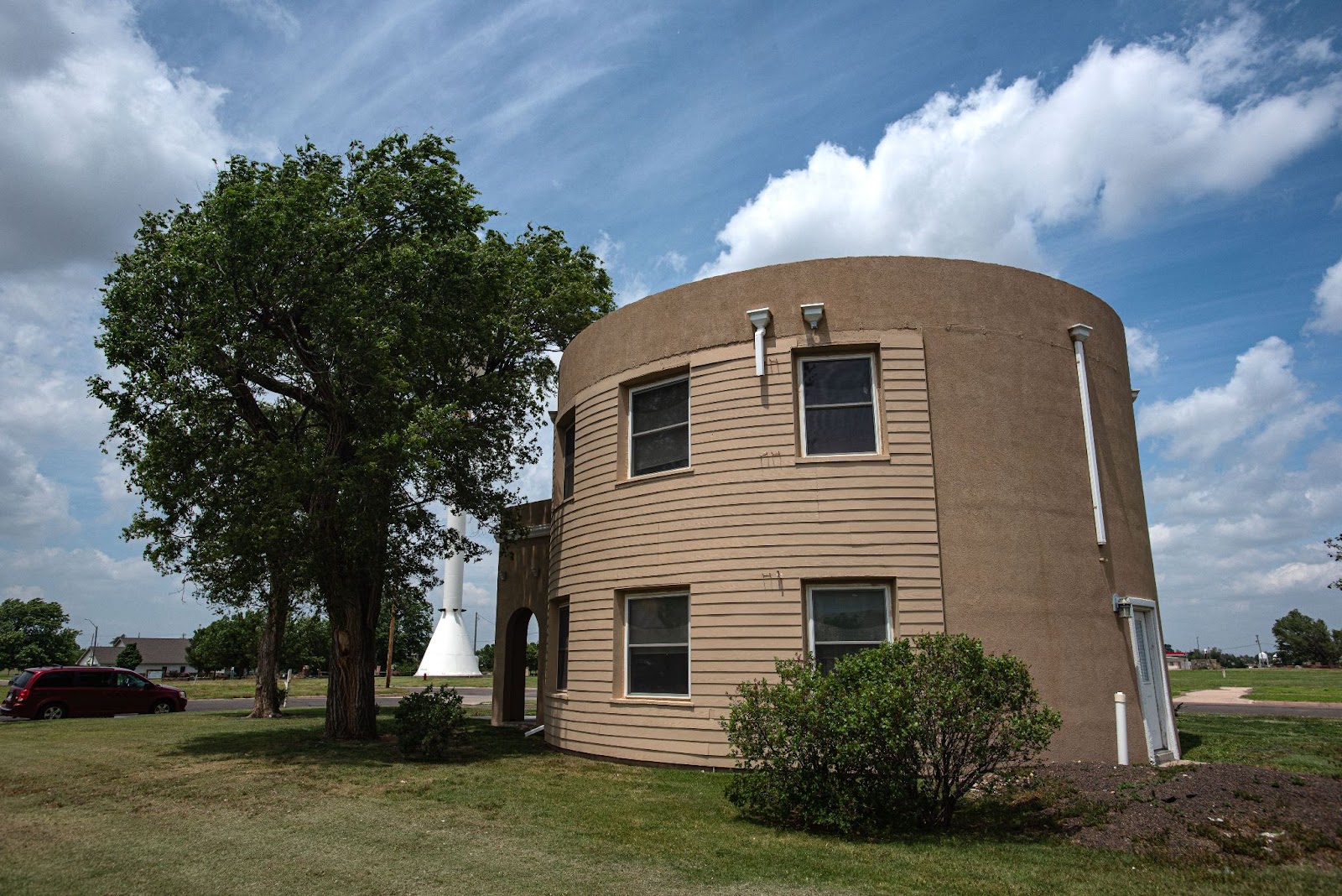 Photo of a cylindrical concrete dwelling with a few windows 