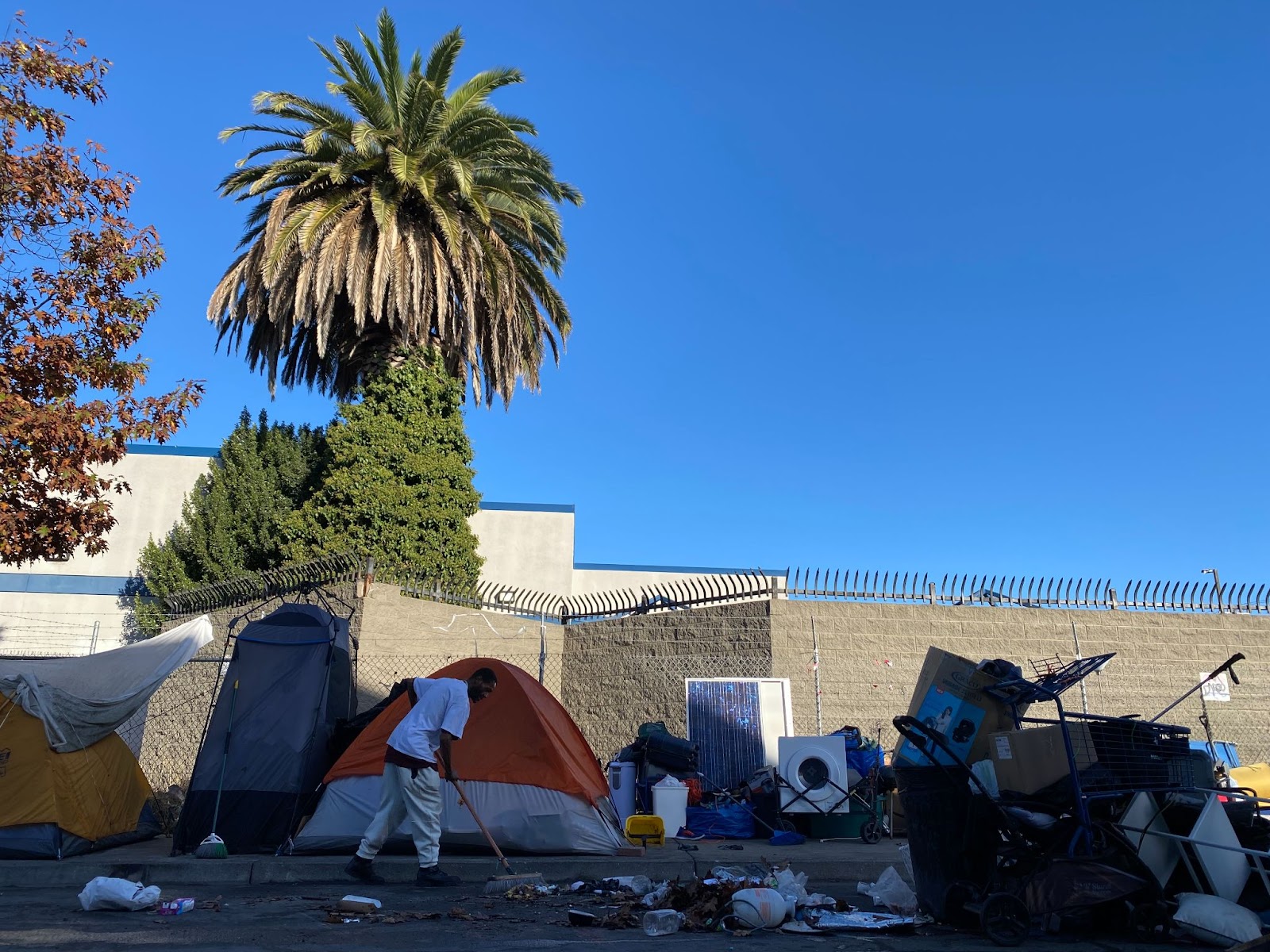 Galtney sweeps debris into a collected pile just outside his camp, November 6, 2023. (Bradley Penner)