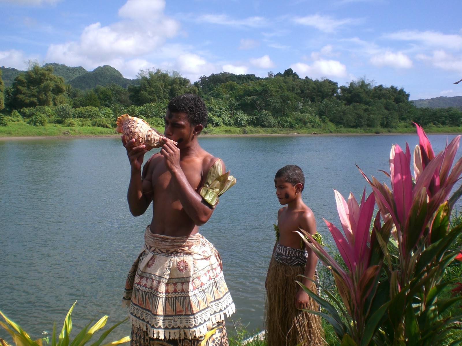 Fijian men taking part in a traditional Fiji culture using shell instruments. 