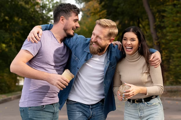Three friends laughing at funny meme captions and having fun.
