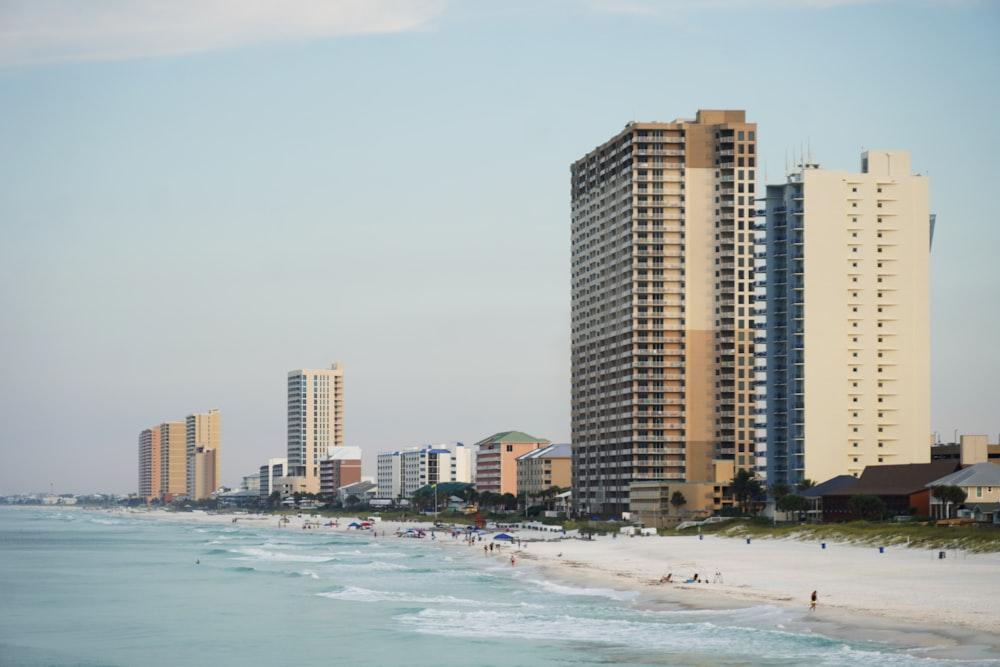 a view of a beach with tall buildings in the background