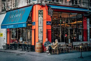 man and woman sitting on chair near store during daytime