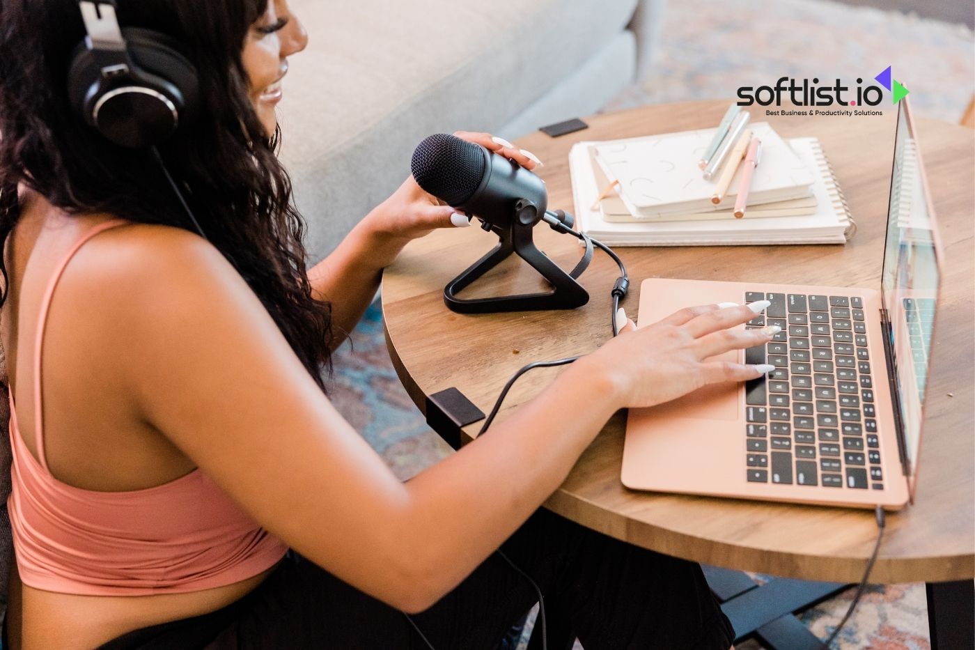 Woman podcasting with laptop and microphone