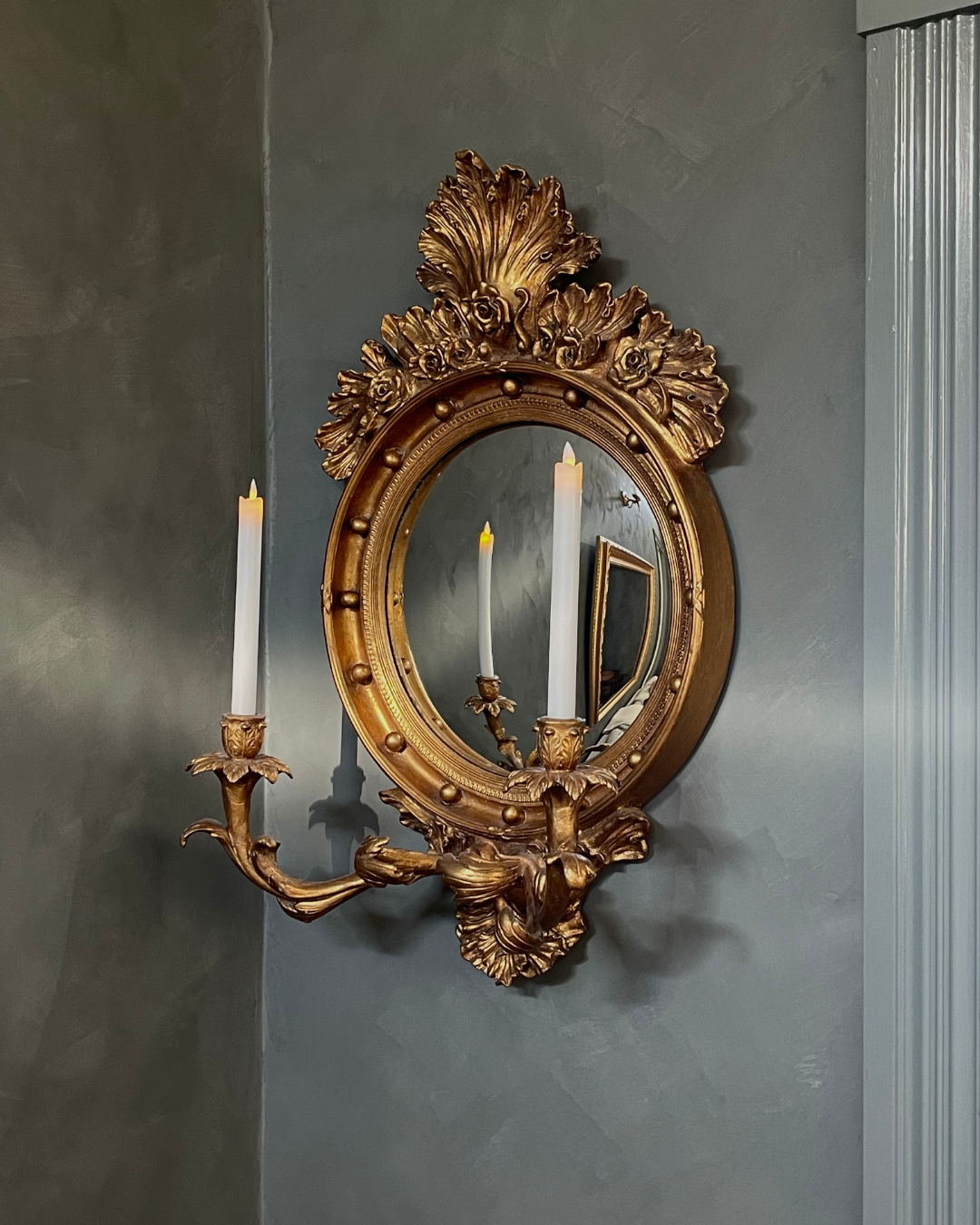 A photo capturing one of the gilded Girandole mirrors that Kim sourced through estate sale.