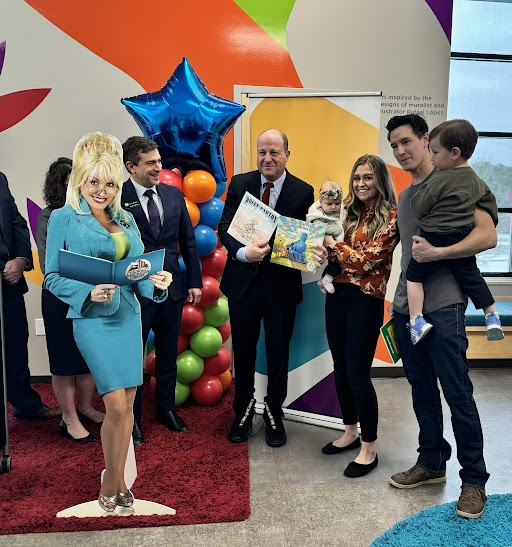 Governor Polis hands out one millionth Imagination Library Book in Colorado and poses with recipients and legislators.