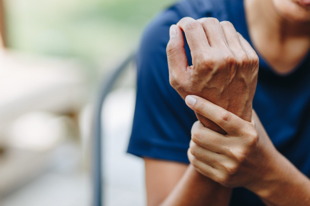 man holding his wrist after a personal injury accident, being helped by a spring hill personal injury lawyer to obtain compensation