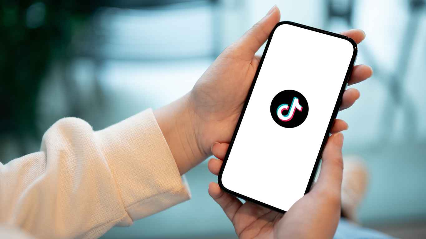 TikTok Follower Counter - A with a mobile device displaying the TikTok logo.