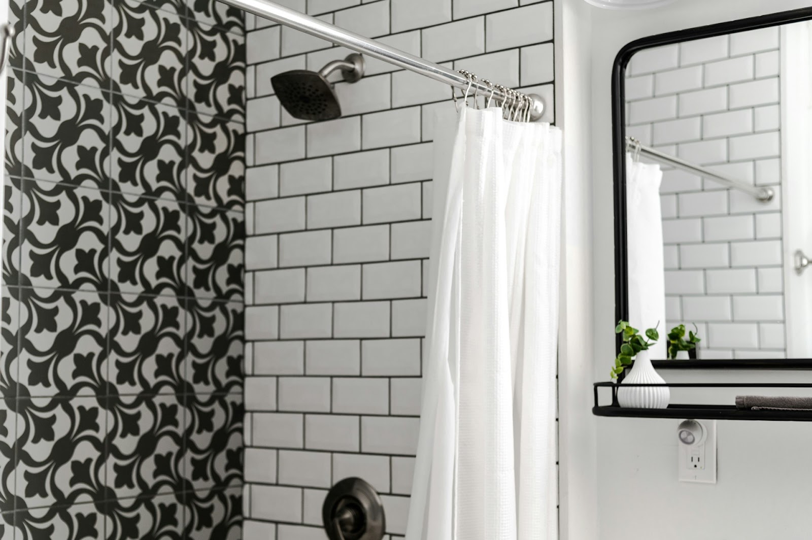 shower with white subway tiles and gray and white tiles